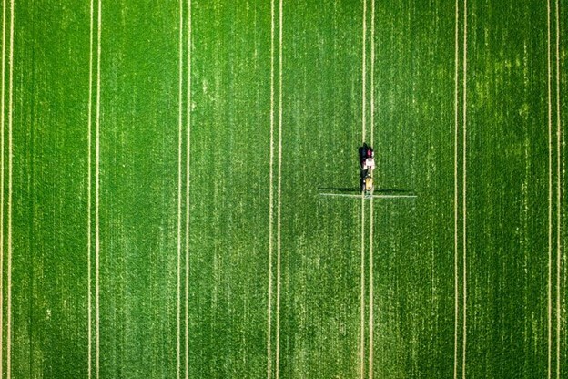 Aerial view of fertilizer spreading on a field.